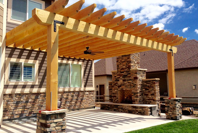Pergola in backyard incorporating wood and brick